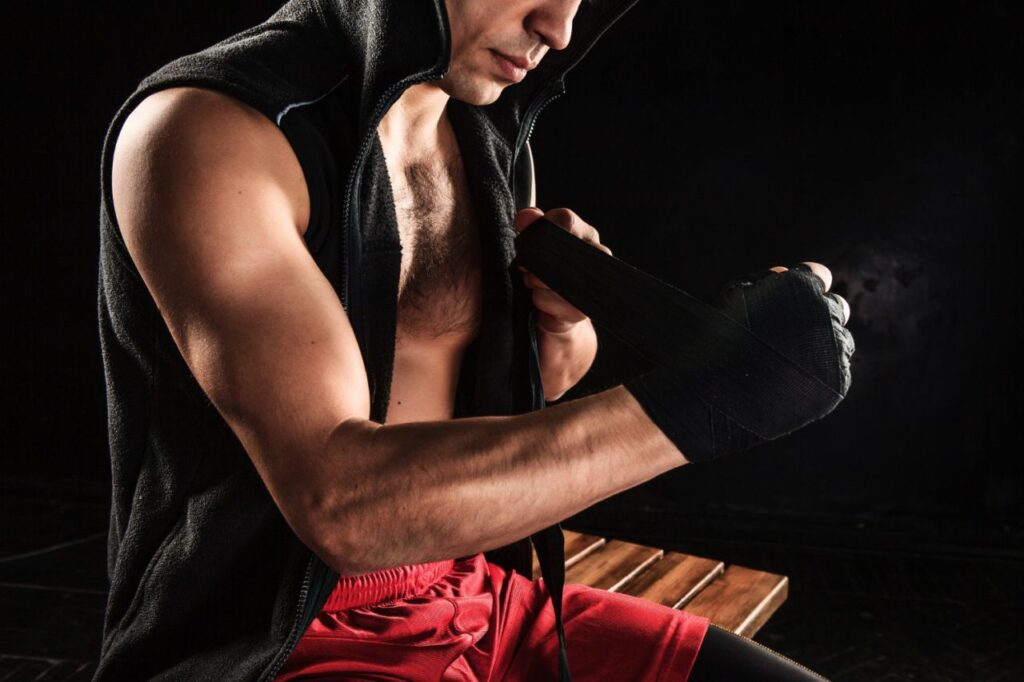 hands with bandage muscular man training kickboxing black